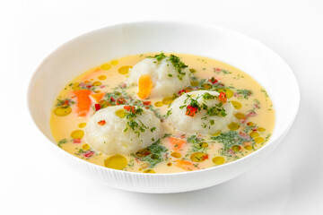 Fragrant first course with chicken broth, cream and meatballs. Dietary cream soup based on baked and fresh vegetables with herbs. Fitness menu. Delivery of prepared food. White background