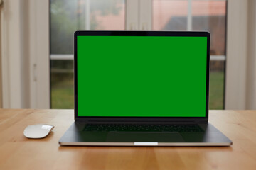 Fototapeta premium Laptop with blank screen on white table with mouse and smartphone. Home interior or office background