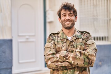 Fototapeta premium Young man army soldier smiling confident standing with arms crossed gesture at street
