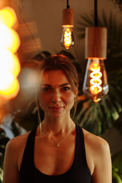 Portrait Of A Woman Among Yellow Light Bulbs