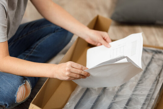 Frustrated contemplation on instructions for assembling furniture.