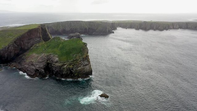 The cliffs and sea stacks An Tor Mor and the Wishing Stone at Port Challa on Tory Island, County Donegal, Ireland
