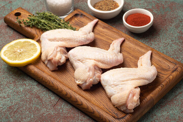 Chicken wings, raw chicken wings, on a textured background