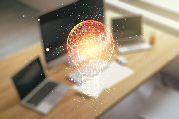 Fototapeta na wymiar Creative idea concept with light bulb illustration and modern desktop with computer on background. Multiexposure