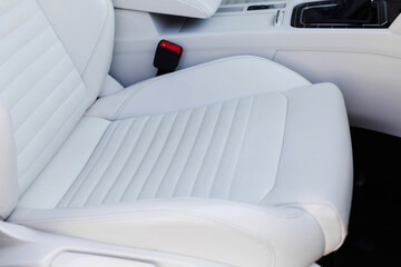 Details of white leather seat in a luxury car.