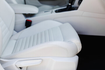 Details of white leather seat in a luxury car.