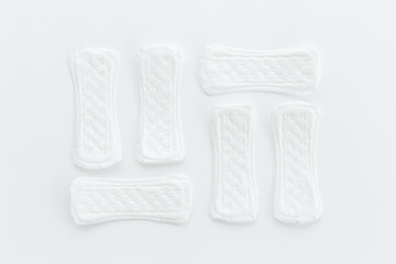 Female hygiene concept. White panty liners pattern, top view