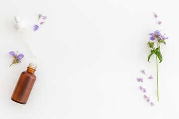 Cosmetic bottle with pipette and medicinal herbs essential oil