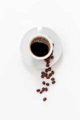 Black coffee - espresso - in white cup with coffee beans