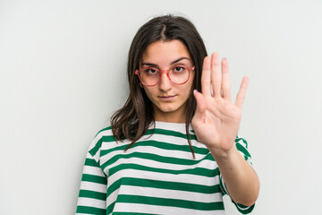 Young caucasian woman wearing a glasses isolated on blue background standing with outstretched hand showing stop sign, preventing you.