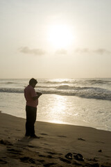 A person walking barefoot in the beach of Bay of Bengal in Chennai