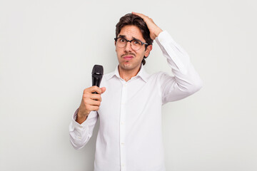 Young hispanic singer man isolated on white background being shocked, she has remembered important...