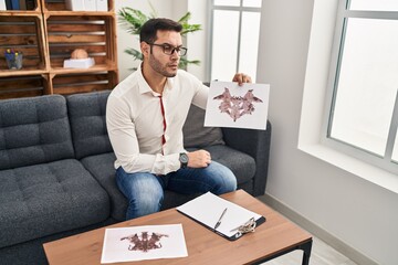 Young hispanic man psychologist having rorscharch test at psychology center