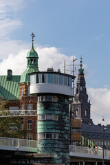 Copenhagen, Denmark The control tower of the moveable Knippels Bridge in the Copenhagen harbor and the tower of the old stock exchange in background.