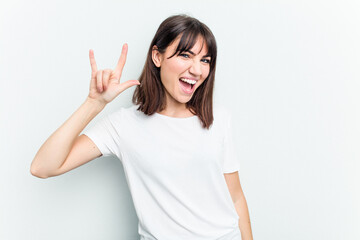 Young caucasian woman isolated on white background showing a horns gesture as a revolution concept.