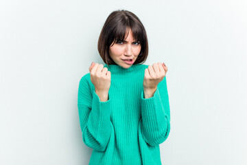 Young caucasian woman isolated on white background upset screaming with tense hands.