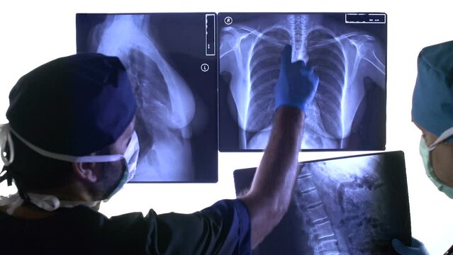 surgeons examine x-rays