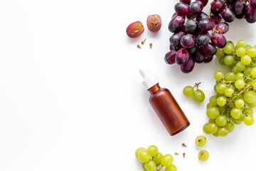 Grape seed essential oil with bunch of grapes. Eco cosmetic product