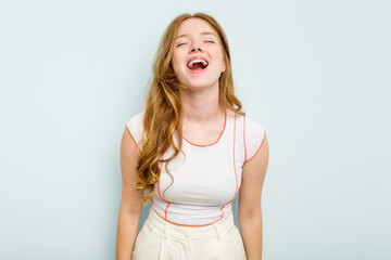 Young caucasian woman isolated on blue background relaxed and happy laughing, neck stretched...