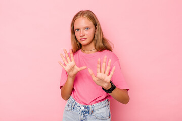 Caucasian teen girl isolated on pink background rejecting someone showing a gesture of disgust.