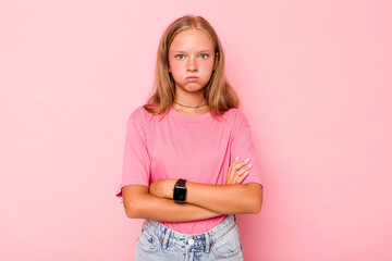 Caucasian teen girl isolated on pink background blows cheeks, has tired expression. Facial...