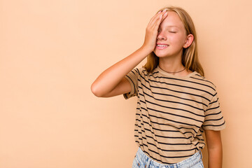 Caucasian teen girl isolated on beige background laughing happy, carefree, natural emotion.