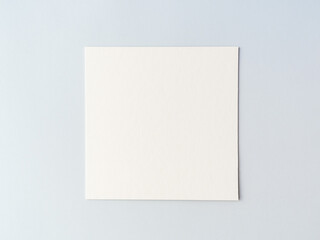 empty square cardboard sheet on a on a blue background. empty space for text