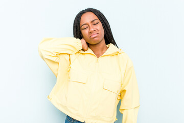 Young African American woman with braids hair isolated on blue background having a neck pain due to stress, massaging and touching it with hand.