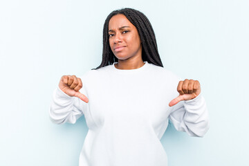 Young African American woman with braids hair isolated on blue background showing thumb down, disappointment concept.