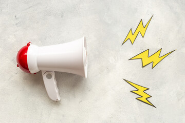 White megaphone with flying lightning. Hot news or advertising concept