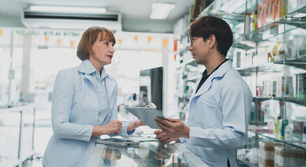 Fototapeta premium pharmacist man advice At the pharmacy.Pharmacist assistant sending prescription to doctor.expertise Pharmacy business.doctor check drug at drugstore.