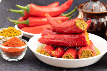 Traditional Homemade Red Chilli Pickle Also Known As Moti Teekhi Lal Mirch Ka Bharwa Bharua Achar Stuffed With Coarsely Powdered Masala Spices Like Seeds Mustard, Fenugreek, Turmeric, Amchur And Hing
