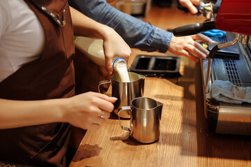 Fototapeta na wymiar Making coffee in a coffee shop on a coffee machine, hands with a cup