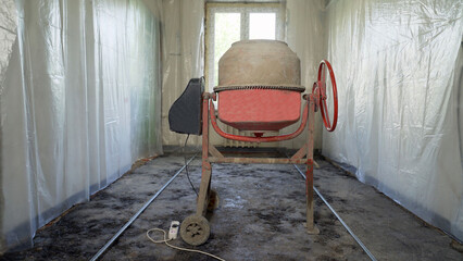 The using the electric concrete mixer in an apartment is under construction, remodeling,...