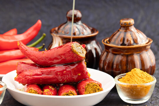 Traditional Homemade Red Chilli Pickle Also Known As Moti Teekhi Lal Mirch Ka Bharwa Bharua Achar Stuffed With Coarsely Powdered Masala Spices Like Seeds Mustard, Fenugreek, Turmeric, Amchur And Hing