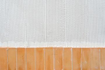 Fototapeta premium White vertical stripe plastered wall. Structural plaster on wall