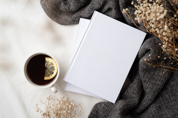 white blank books with gray plaid, cup of lemon tea and dry flowers , mockup design