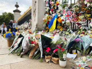 Many flowers and funeral cards at Buckingham Palace in London UK to mourn the death of Queen...