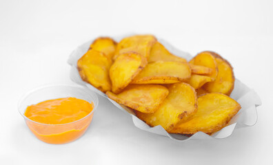 Homemade Potato Chips with Cheddar Sauce, white isolated background