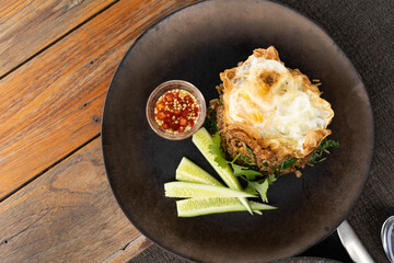 Minced pork with basil rice with fried egg, laying on the wooden floor, top view