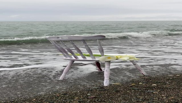 white chair with flowers on the beach