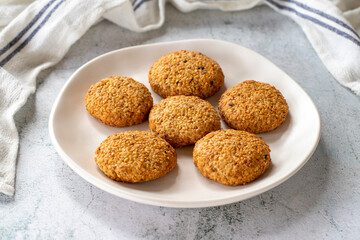 Sesame cookies. Freshly baked salty cookies on a gray background. close up