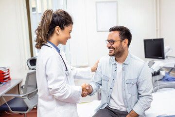 Smiling young female doctor shake hand close health insurance deal with elderly patient at...