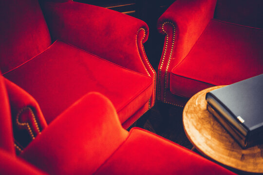 Red Sofas And A Table With A Book