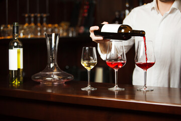 Sommelier pouring different types of fine wine