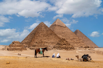 Cairo, Egypt. 08.25.2022. Group of tourists watching the Panoramic view of the pyramids of Micerino, Kefren and Cheops.