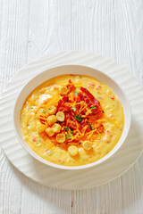 savory creamy pumpkin soup in bowl, top view