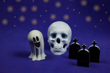 Halloween skull, ghost and tombstones with purple background