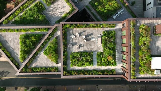 Rising aerial, outdoor living space. Green rooftop garden in urban city. Carbon emissions, climate change ESG theme,