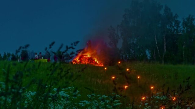 Static shot of tourists group by the campfire under the night starry sky during evening time in timelapse.